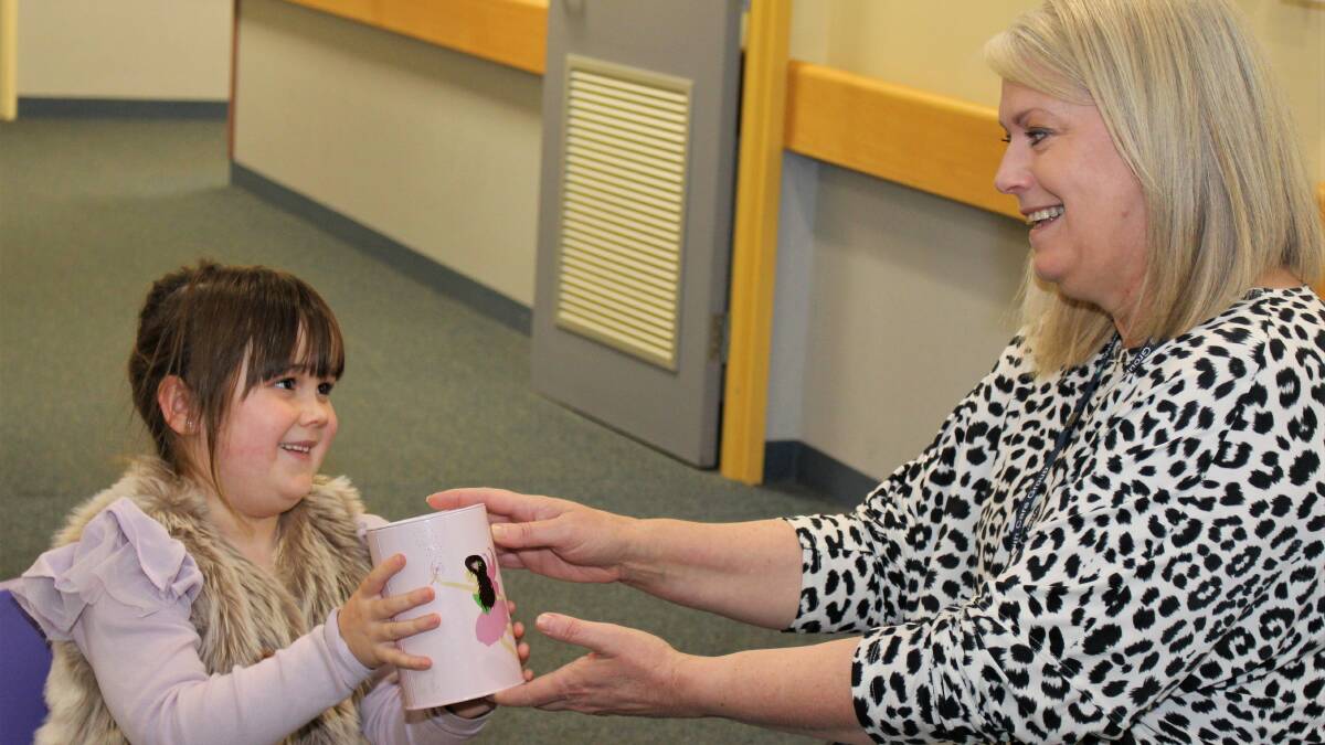 Ella Ryan giving her pocket money to Wimmera Health Care Group clinical risk manager Roxanne Tucker. Picture: PETER MILLER