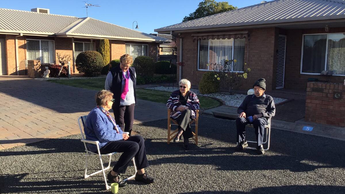 GROSS COURT: residents catching up at 3pm whilst social distancing. Picture: DI BELL