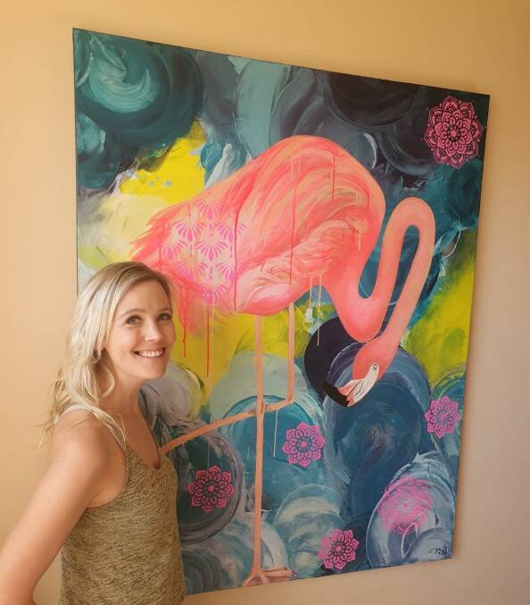 SOLO EXHIBITION: Artist Rebecca Warr with recently sold work Fancy Fluro Flamingo. Picture: CONTRIBUTED