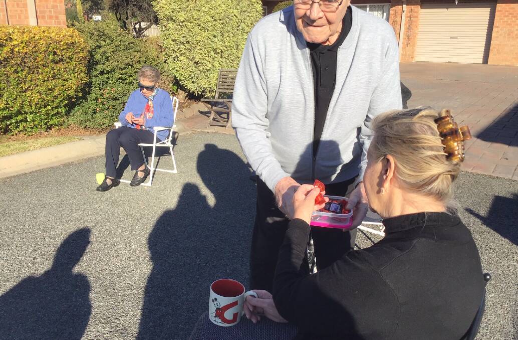 AFTERNOON TEA: Hans Watig handing out chocolates to Gross Court residents. Picture: DI BELL