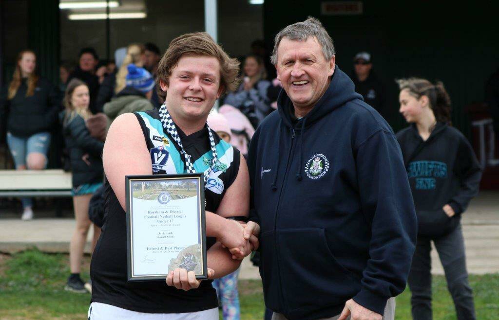 HONOUR: Josh Leith, of the Stawell Swifts, receives his award from Horsham Blue Ribbon Foundation member Les Power.