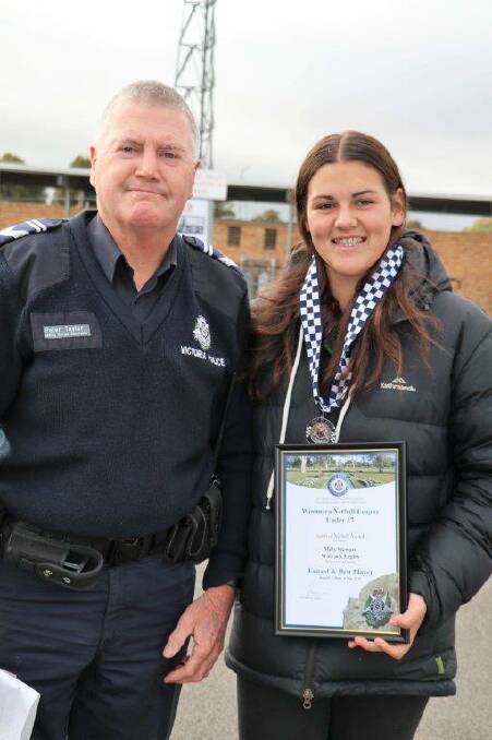 HONOUR: Molly Stewart receives her award at the netball from Warracknabeal police officer Leading Senior Constable Peter Taylor.