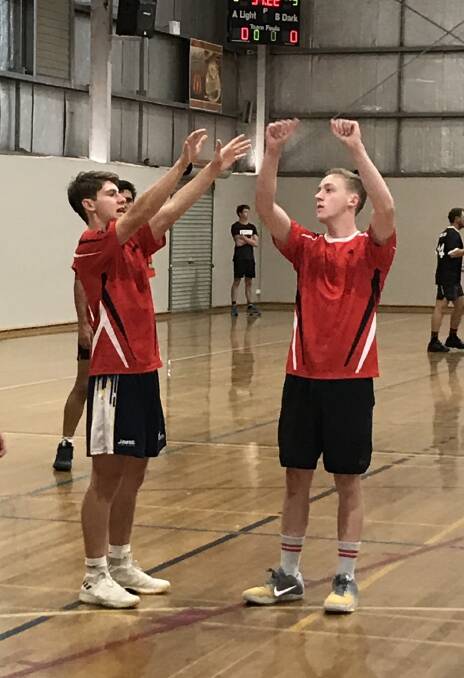 ADVICE: Raptors' John Kearns showing youngster Nathan Sparke the correct blocking technique.