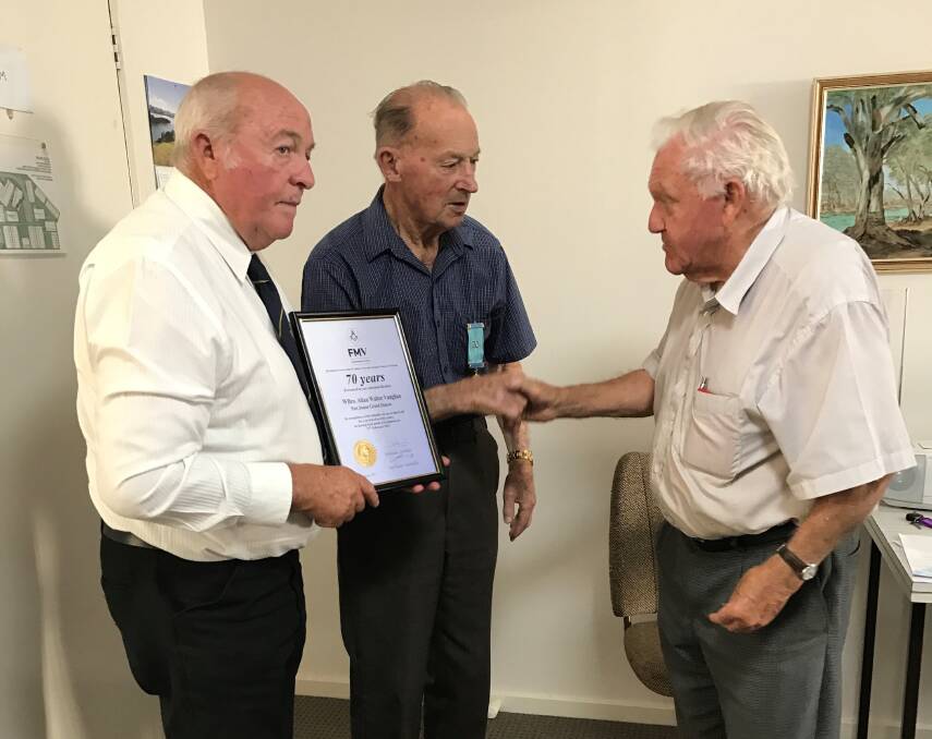 HONOUR: WBro Allan Vaughan PJGD is congratulated by WBro Ian Ballinger PGStdB (right) and VWBro Noel Taylor PGIWkgs GLHer (left) on receiving his 70 Year Jewel.
