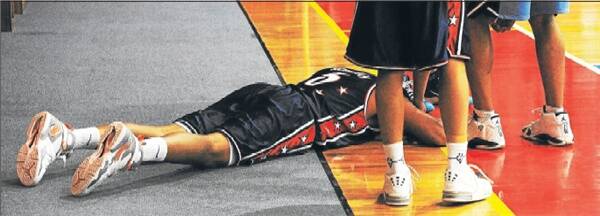 ... MUST COME DOWN: Skurrie lies on the ground after being taken down by Giants forward Jonathan Hall. Hall received an unsportsmanlike foul and Skurrie recovered and finished with 23 points.