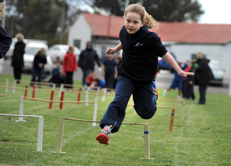Murtoa College junior campus student Jenna McCallum, 8, bounds over the hurdles. Picture: PAUL CARRACHER
