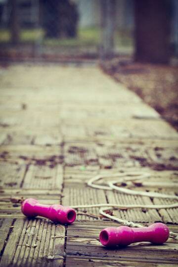 Pink skipping rope on ground