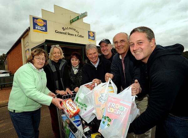 GENERAL STORE PURCHASE IN THE BAG: Balmoral General Store staff member Jan Grambeau, former owner Prue Leeming, staff member Larisa Williams and new shareholders Tom Silcock, Adrian Watt, John Vitkovsky and Matthew Whiting celebrate the community banding together to buy the business. Picture: PAUL CARRACHER