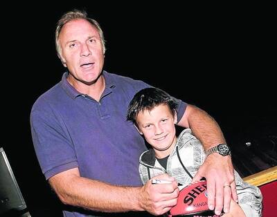 TACKLE: Dimboola's Lucas Harberger, 10, with former Essendon captain Tim Watson.