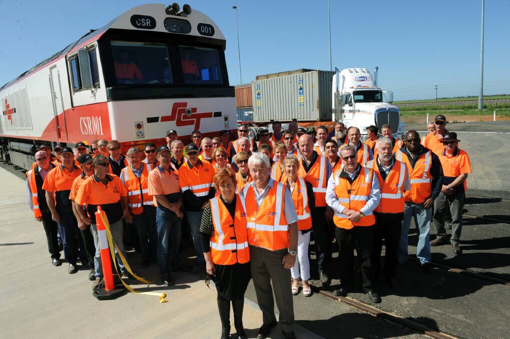 Wimmera Container Line owners Rodney and Jenny Clarke welcome the fi rst train into the company’s new base at the Wimmera Intermodal Freight Terminal at Dooen yesterday, fl anked by company management, staff and customers. Picture: PAUL CARRACHER