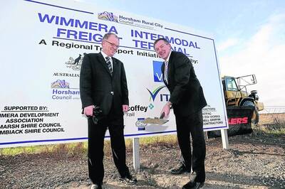 FIRST SOD: Horsham Mayor Michael Ryan and Member for Lowan Hugh Delahunty celebrate the beginning of work on the Wimmera Intermodal Freight Terminal at a ceremony yesterday. Picture: KATE HEALY