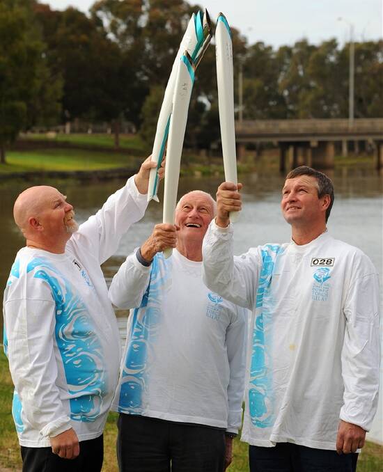 KEEPING THE FLAME BURNING: Sydney Olympic torch bearers Kinglsey Dalgleish, Ray Wickham and Andrew Weidermann reminisce about the flame coming to the Wimmera 10 years ago. Picture: KATE HEALY