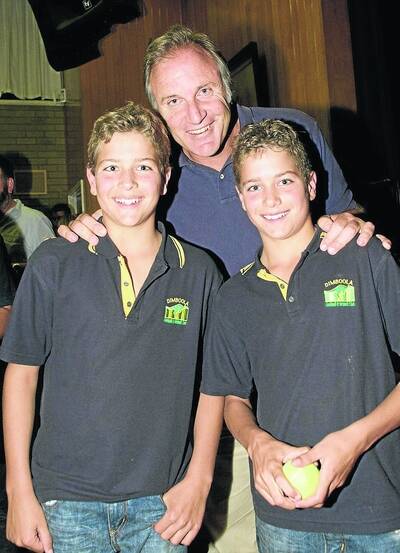 YOUNG FANS: Twins Scott and Mark Polycarpou, 12, take up a photo opportunity with Tim Watson on Friday night.