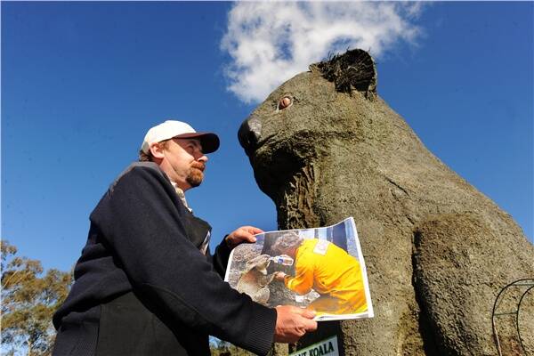 BIG PLANS: Giant Koala owner Rob McPherson with the world-famous image of CFA volunteer David Tree giving water to fire victim Sam. Mr Tree will attend an event at Dadswells Bridge next month where the Giant Koala will be named in honour of Sam and an information centre about the welfare of koalas launched. Picture: KATE HEALY
