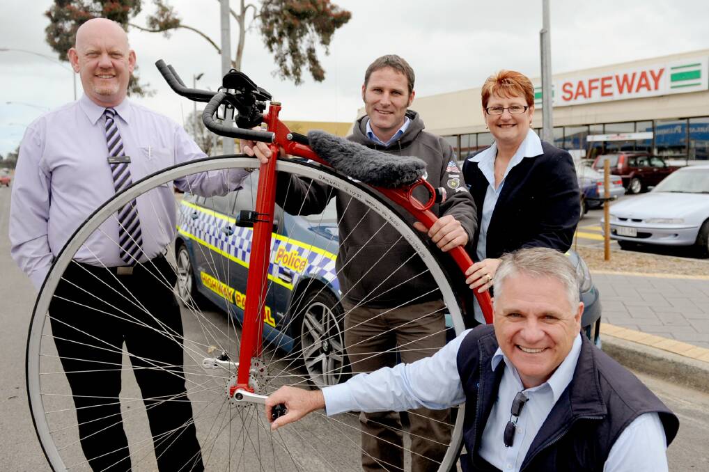 BIG WHEELS: Horsham Safeway store manager Glen Cooney, left, rider Dan Bolwell, centre, and Viv Watson and Graeme Eldridge, from Community Axis, with the penny farthing Mr Bolwell will ride for eight days. Picture: SAMANTHA CAMARRI