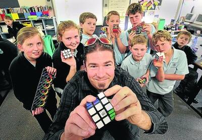KEEN CUBER: Horsham man Jonothon Holmes-Brown teaches the art of cubing to his St Mary's Primary School, Warracknabeal, students Rachel Kemp, Madison Wilson, William Martin, Max McCoy, Charlie Dean, Jack Wyllie, Zavier Inkster and Owen Johns. Picture: PAUL CARRACHER