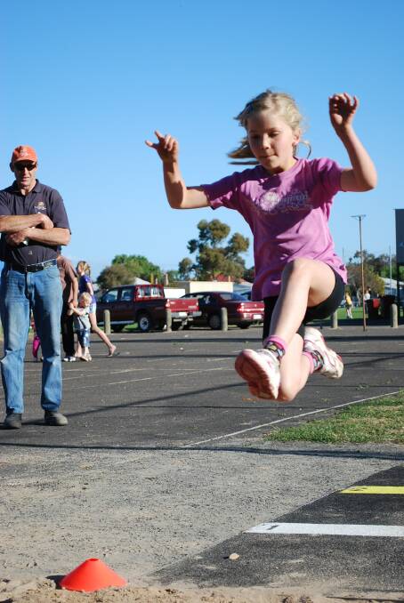 Kelly Grey tries the long jump in the under-eights.