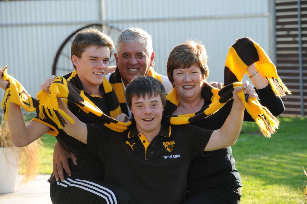 Clinton Young's family, Blake, left, Laurie, Bev and Lachlan, front, will be at the MCG tomorrow to cheer on the Hawks.