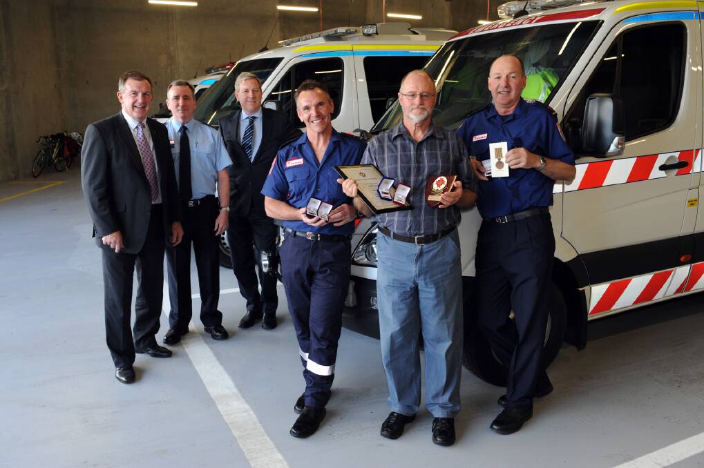 Horsham paramedics Roger Murray, Brian Campbell and Trevor Lehmann with the long-service awards they received at the official opening of the new Horsham ambulance station yesterday. They pictured with Member for Lowan Hugh Delahunty, Ambulance Victoria chief executive Greg Sassella and Health Minister David Davis, who officially opened the station. Picture: PAUL CARRACHER