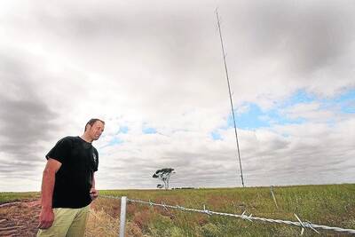 EARLY DAYS: Murra Warra farmer David Jochinke has a wind testing station on his farm. The 70-metre  pole sends data to a renewable energy company considering developing a wind farm in the area. Picture: PAUL CARRACHER
