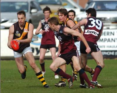 Brett Cook sets up an attack for Kyneton in this clash with Sandhurst.