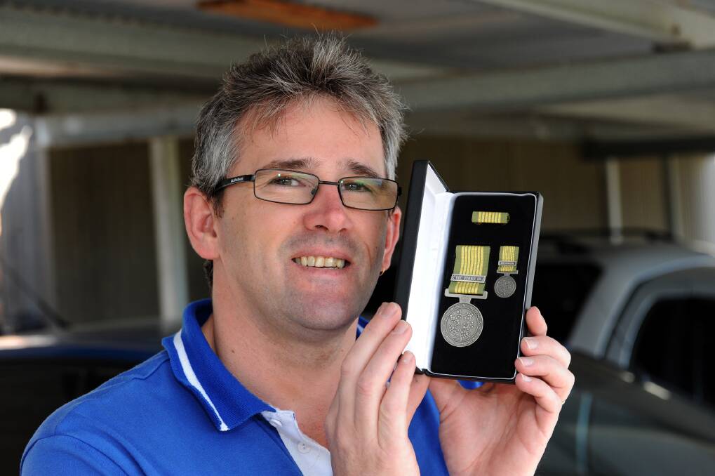 Horsham's Graham Hill with his National Emergency Medal. Picture: PAUL CARRACHER