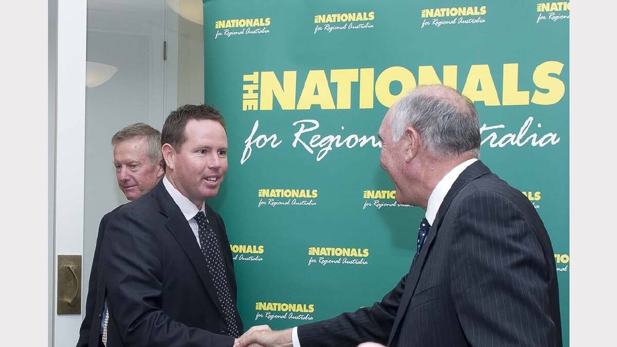 Nationals leader Warren Truss, right, greets new  Member for Mallee Andrew Broad in the party room in Canberra.