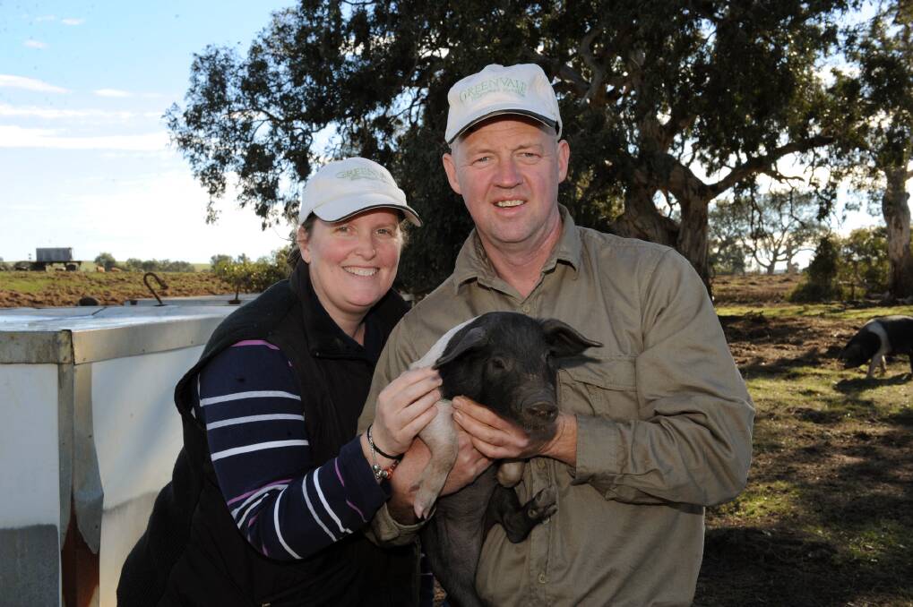 HAPPY AS: Amanda and Anthony Kumnick with a Wessex saddleback pig on their Greenvale Farm at Willaura. The farm is one of two Wimmera producers listed as a finalist in the 2013 ABC Delicious Magazine produce awards. Picture: PAUL CARRACHER