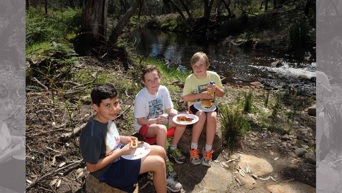 Max Demetriades, 11, Marcus Etheridge, 12, and Dougal Etheridge, 11, enjoy what generations of kids did, a barbecue at Zumsteins. 