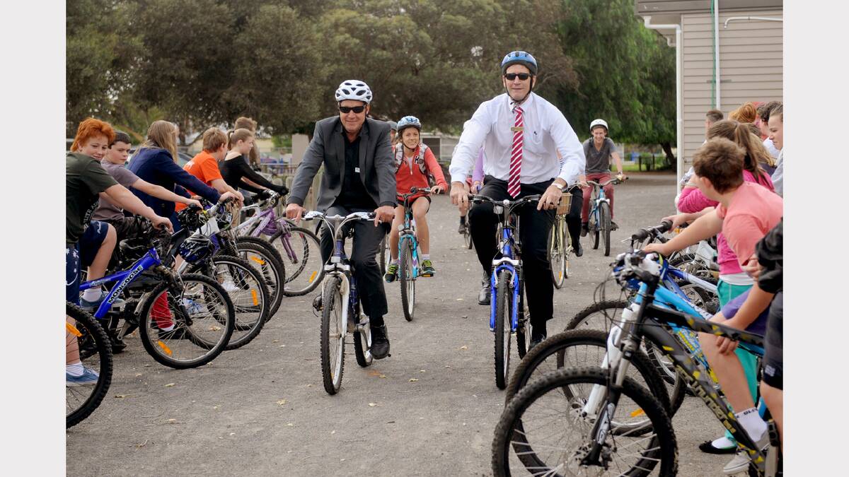 Cr Robin Barber and Horsham College Principal Frank Spiel, riding through an honour of students on their bikes for Ride to School day and the opening of the College's new bike shed 