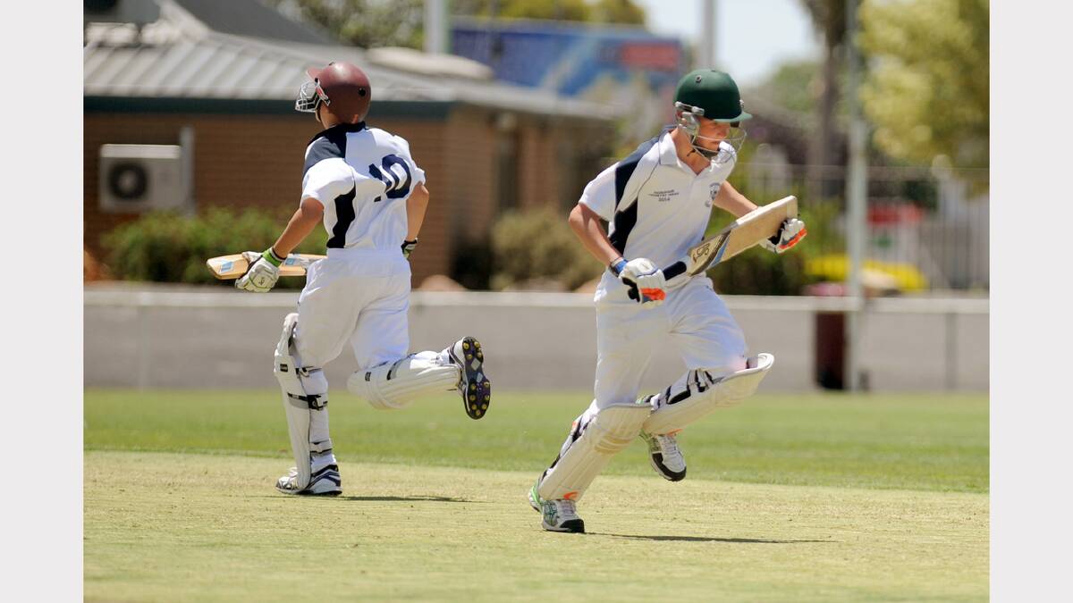 ON THE MOVE: Will Fleming and Connor McLeod of Warrnambool Gold scamper through for a single during the Horsham under-15 Country Week grand final against South West. Picture: SAMANTHA CAMARRI