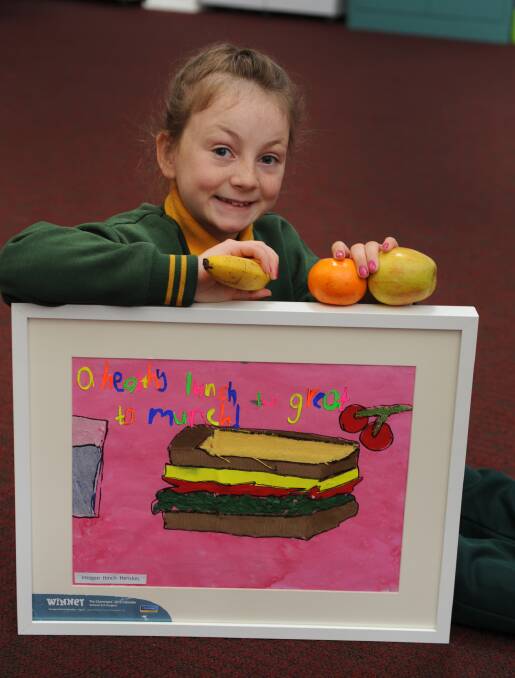 Imogen Hinch-Henskes, 9, with her award-winning piece of art that promotes healthy eating. Picture: PAUL CARRACHER