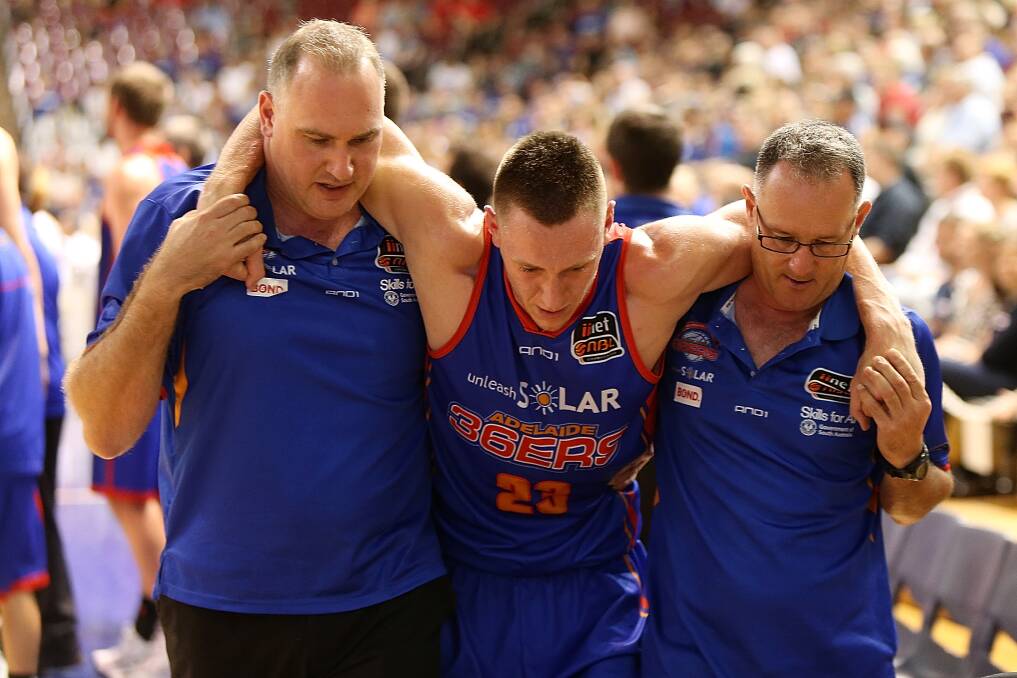 Former Horsham basketballer Mitch Creek is helped from court. Picture: GETTY IMAGES