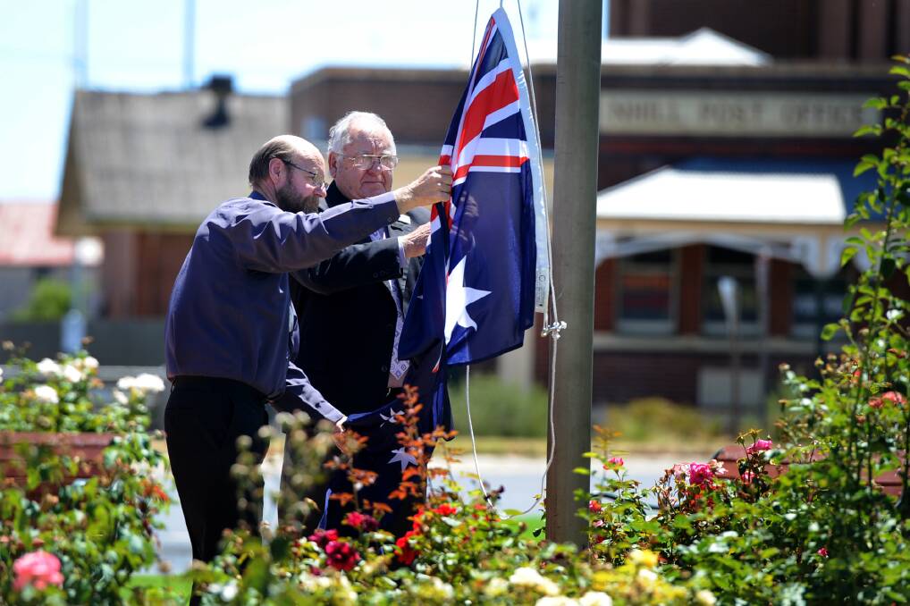 HONOUR: Nhill Lions Club president Ian Meek and Hindmarsh Mayor Rob Gersch raise the flag at Nhill's Australia Day ceremony on Sunday. Picture: SAMANTHA CAMARRI