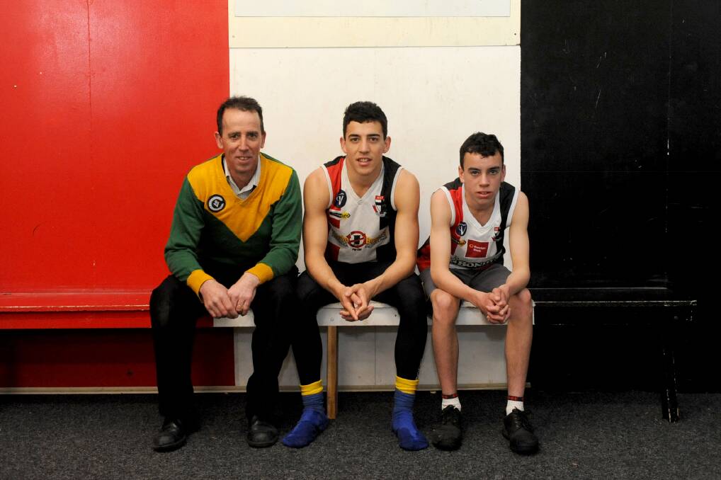 FAMILY TIES: Horsham Saints under-14s coach Mark ‘Chad’ O’Beirne with his two sons, Jacob, 17, and Connor, 14. Jacob will play in the Saints’ senior grand final, while Connor will feature in the under-14s grand final. Picture: SAMANTHA CAMARRI