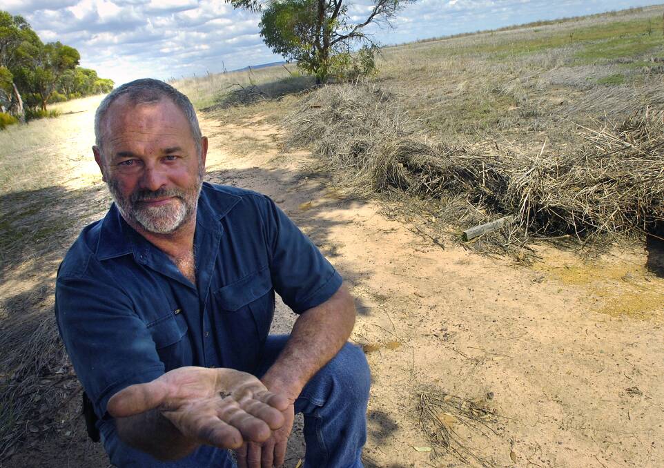 Bob Mackley with GM canola seeds in 2011. Picture: AMY PYSDEN