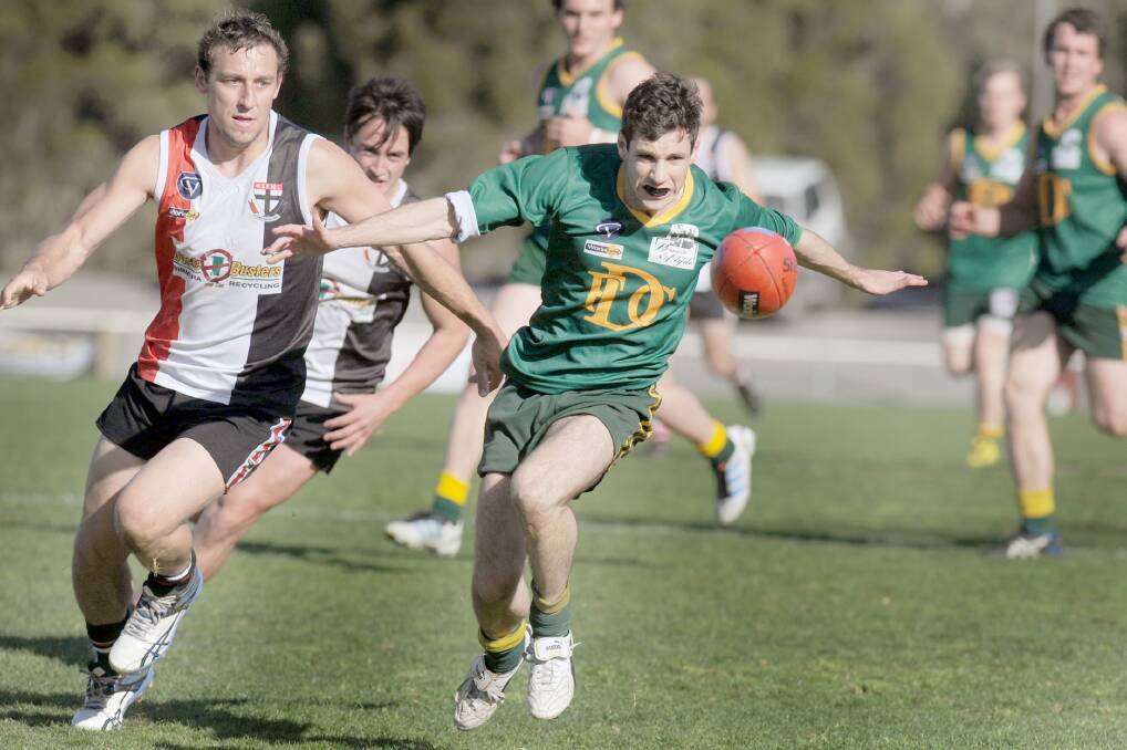 Dimboola's Oliver Braithwaite leads Saints player Ben Myerscough to the ball in yesterday's Wimmera Football League first semi final, at Horsham City Oval. Picture: SAMANTHA CAMARRI