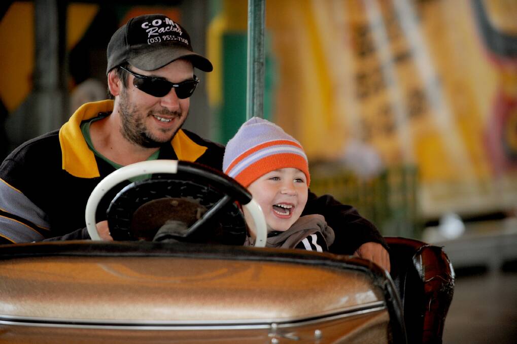 Warracknabeal's David Cook with son Alex Ferguson, 5, race the dodgem cars at the Warracknabeal Show. Picture: EMMA COUTTS
